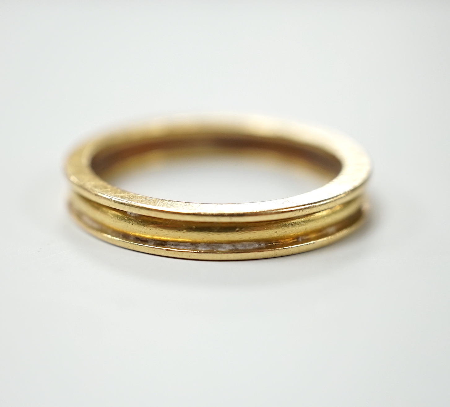 A modern Theo Fennel 18ct gold band, size R, gross weight 4.8 grams.